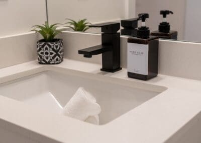 White sink with folded face towels in sink