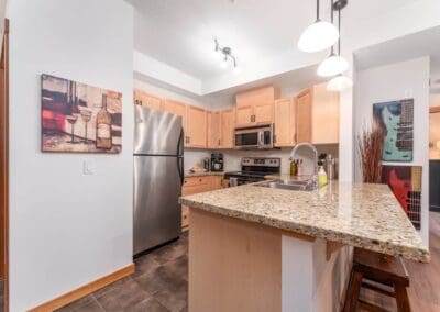 small kitchen with granite top and bar stool